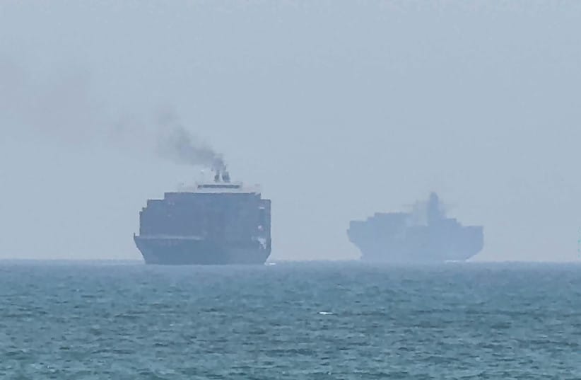 This frame grab taken from AFPTV video footage on July 12, 2026 shows cargo ships anchoring near the Strait of Hormuz off the eastern coast of the United Arab Emirates at Khor Fakkan.