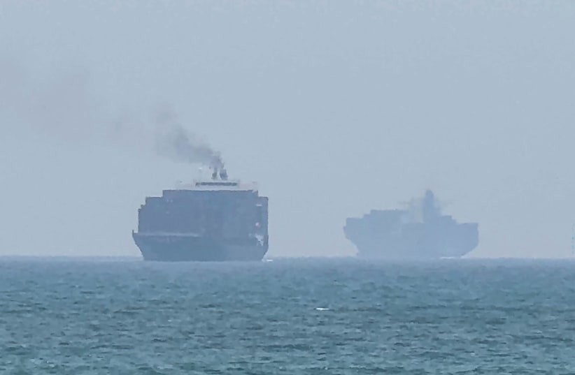 This frame grab taken from AFPTV video footage on July 12, 2026 shows cargo ships anchoring near the Strait of Hormuz off the eastern coast of the United Arab Emirates at Khor Fakkan.