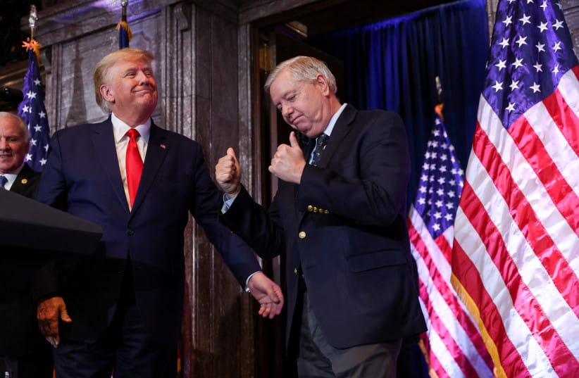 US Senator Lindsey Graham (R-SC) gestures, while standing next to former US President Donald Trump, during Donald Trump's campaign stop to unveil his leadership team, at the South Carolina State House in Columbia, South Carolina, US, January 28, 2023.