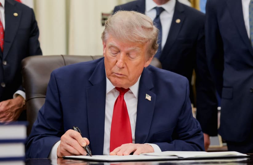 US President Donald Trump signs an executive order related to Utah protected lands in the Oval Office at the White House in Washington, DC, US, July 13, 2026.