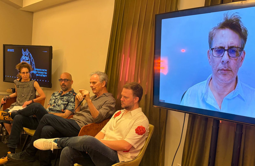Alissa Simon, Yoav Abramovich, Avi Nesher, Emilio Schenker, and Danny Cohen (on the screen) spoke at a panel on Israeli film at the Jerusalem Film Festival.