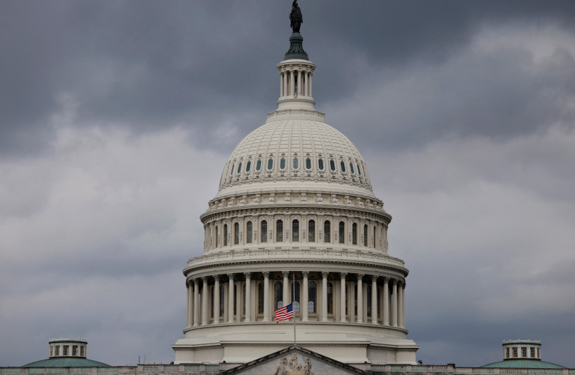 The U.S. flag flies at half staff outside of the US Capitol building.