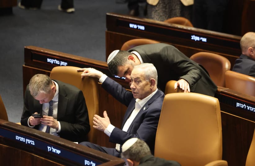 Prime Minister Benjamin Netanyahu and Communications Minister Shlomo Karhi are seen in the Knesset plenum during a vote on the minister's communications reform, in Jerusalem, July 16, 2026