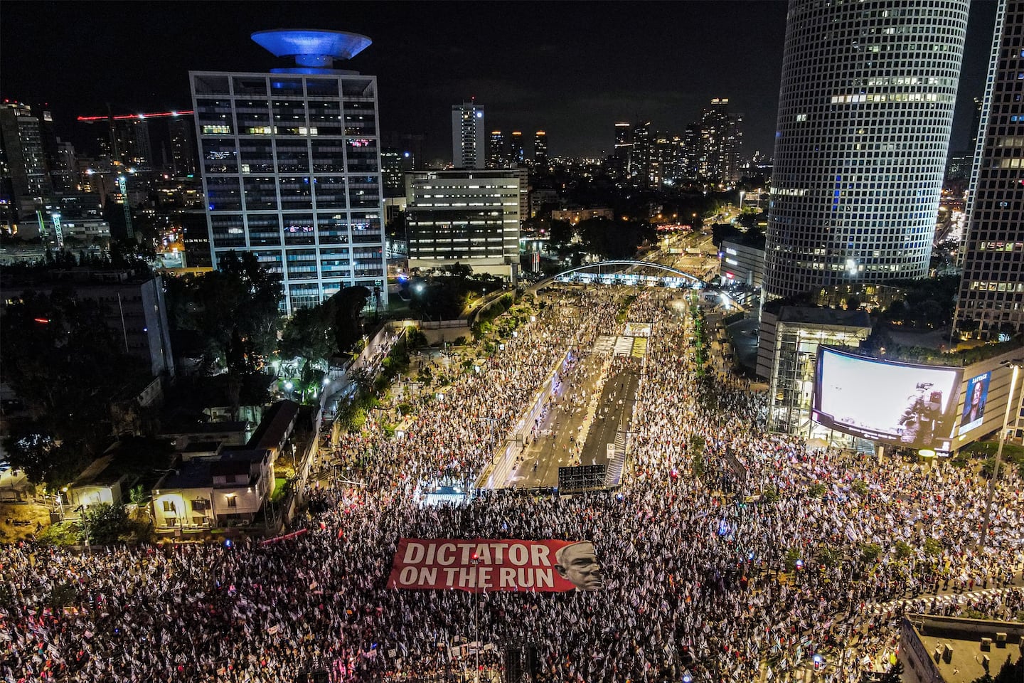 Demonstrators unfurled a giant banner protesting Israeli Prime Minister Benjamin Netanyahu's judicial overhaul plan in Tel Aviv in September 2023. Hamas's assault on Israel would come not long after. 