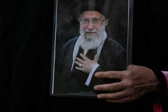 Supreme Leader Ayatollah Ali Khamenei A woman holds a poster of the late Iranian Supreme Leader Ayatollah Ali Khamenei during his funeral procession in Tehran, Iran, Monday, July 6, 2026.