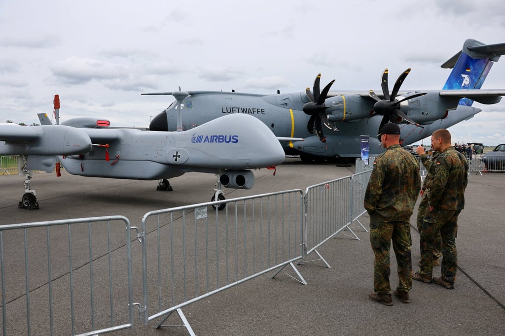 Members of the German air force look at a German Heron TP drone at the International Aerospace Exhibition ILA at Schoenefeld Airport, south of Berlin, in June. Photo: Reuters