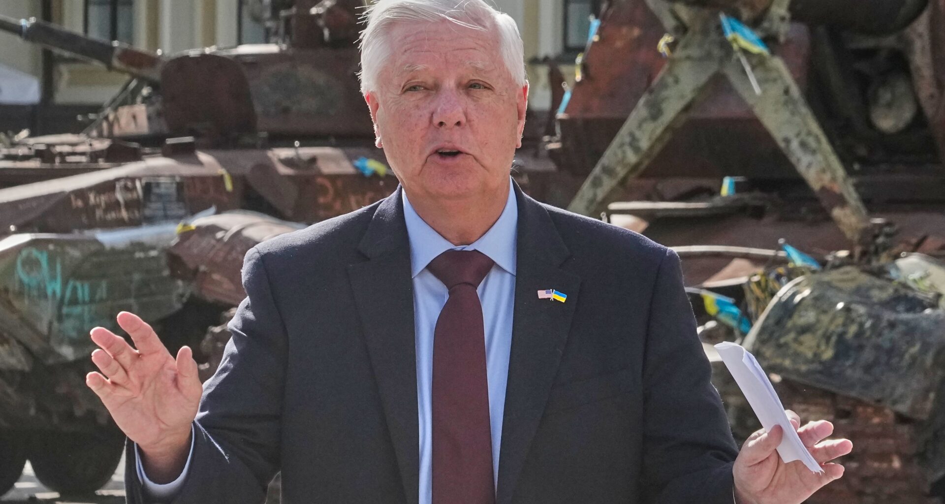 U.S. Sen. Lindsey Graham, R-S.C. answers a question from a media member near damaged Russian vehicles on display in central Kyiv, Ukraine, Friday, July 10, 2026. (AP Photo/Efrem Lukatsky)