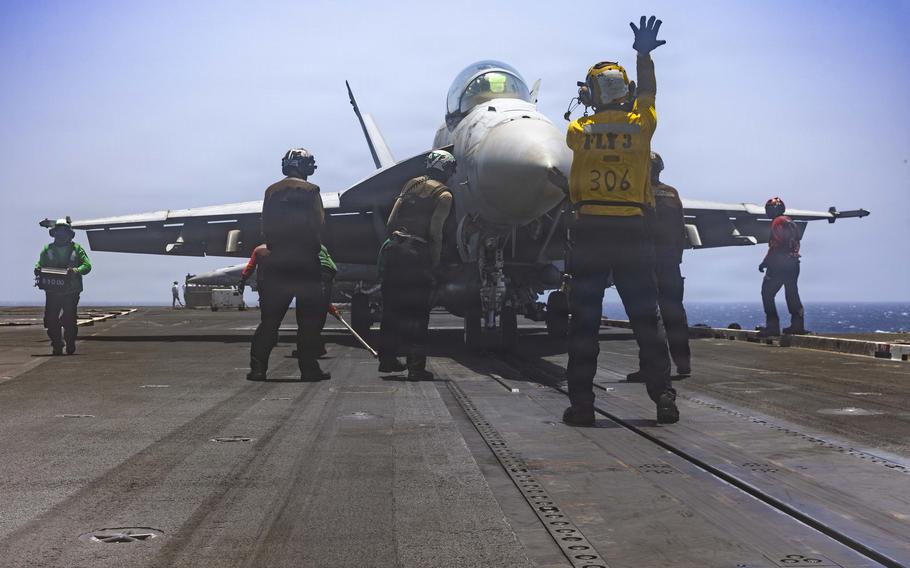 The deck crew makes sure the fighter jet is ready to go.