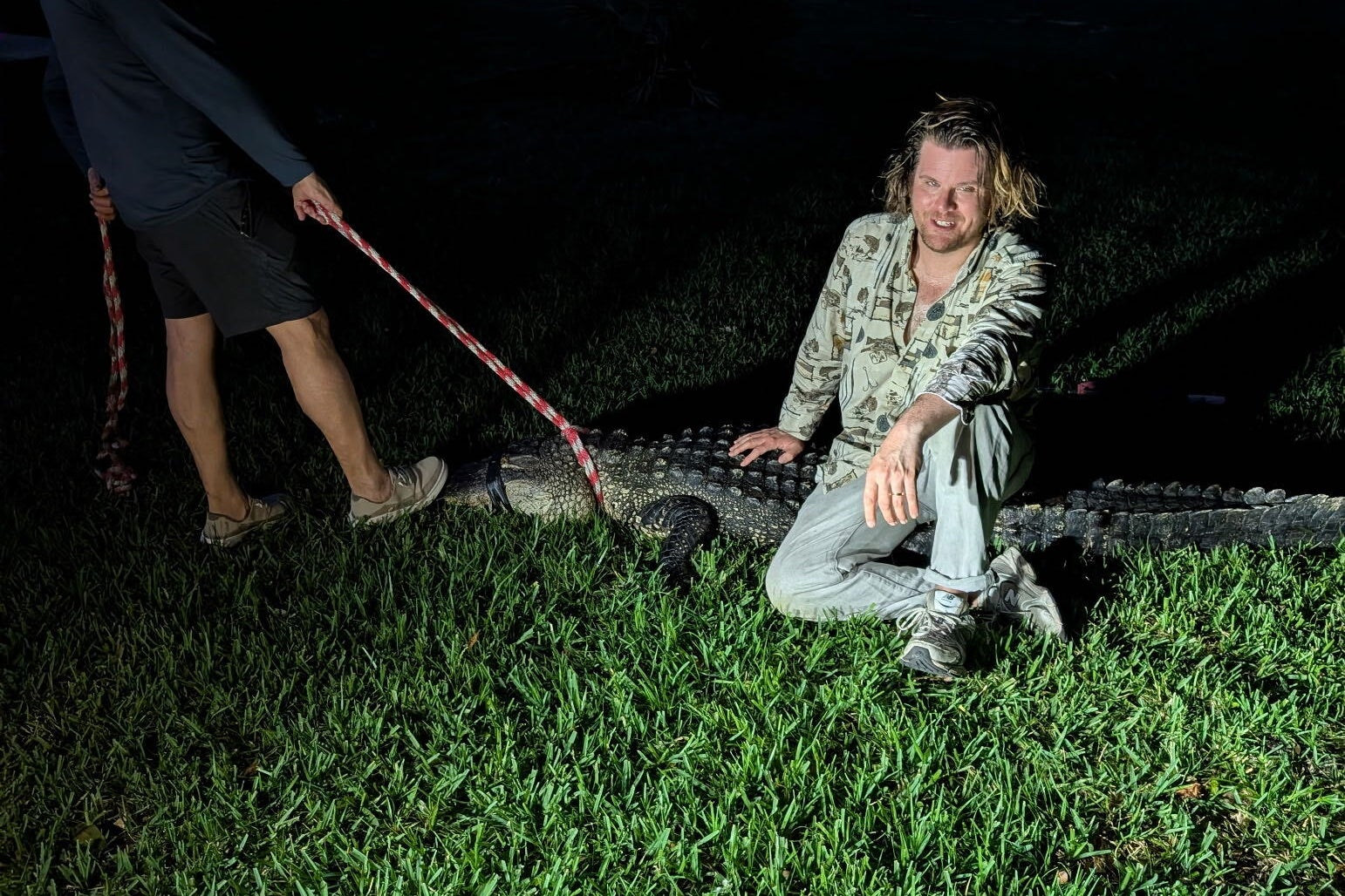 Slate writer Luke Winkie posing with an alligator in Florida
