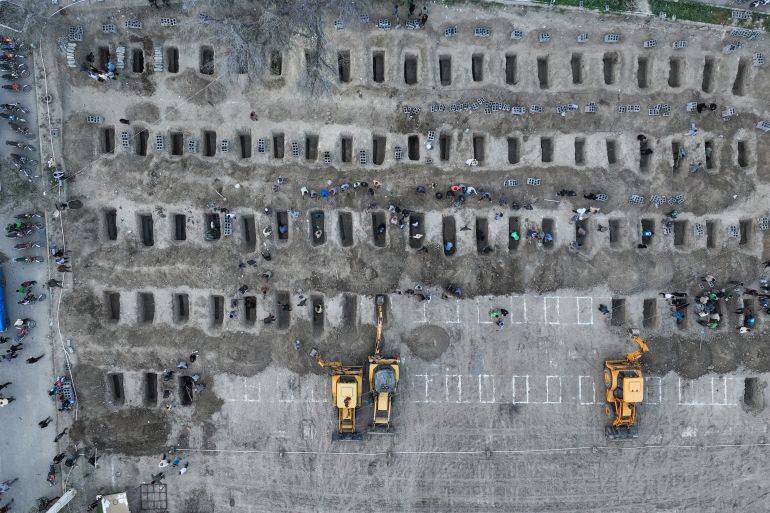 Mourners dig graves for children killed in a strike on a primary school in Minab in Iran’s Hormozgan province on March 3, 2026