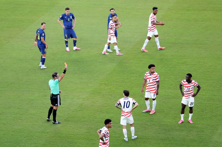 SANTA CLARA, CALIFORNIA - JULY 01: Referee Raphael Claus shows Folarin Balogun #20 of the United States a red card for a foul on Tarik Muharemovic #4 of Bosnia and Herzegovina during the FIFA World Cup 2026 Round of 32 match between USA and Bosnia and Herzegovina at San Francisco Bay Area Stadium on July 01, 2026 in Santa Clara, California. Michael Steele/Getty Images/AFP (Photo by MICHAEL STEELE / GETTY IMAGES NORTH AMERICA / Getty Images via AFP)