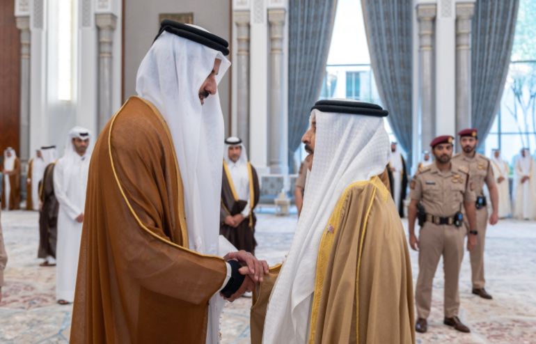 This handout photograph realeased by Qatar's Amiri Diwan shows Qatar's Emir Sheikh Tamim bin Hamad Al Thani (L) receiving condolences from King Hamad bin Isa Al Khalifa, King of Bahrain,