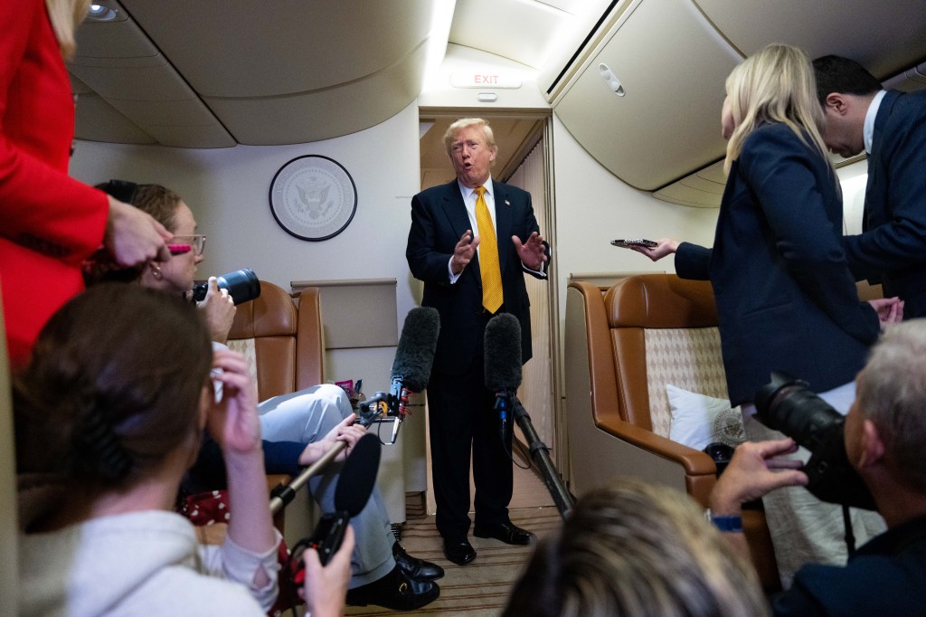 President Donald Trump speaks with reporters in flight on Air Force One after landing at U.S. Air Force Base at RAF Mildenhall, in Suffolk, Eastern England, Wednesday, July 8, 2026. (AP Photo/Alex Brandon)
