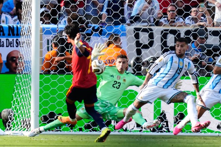 Spain’s Ferran Torres scores the winning goal past Argentina goalkeeper Emiliano Martinez