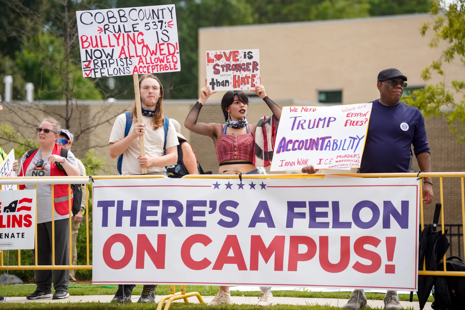 Protestors gather in Marietta while waiting for President Donald Trump to speak at Wheeler High School on July 22.