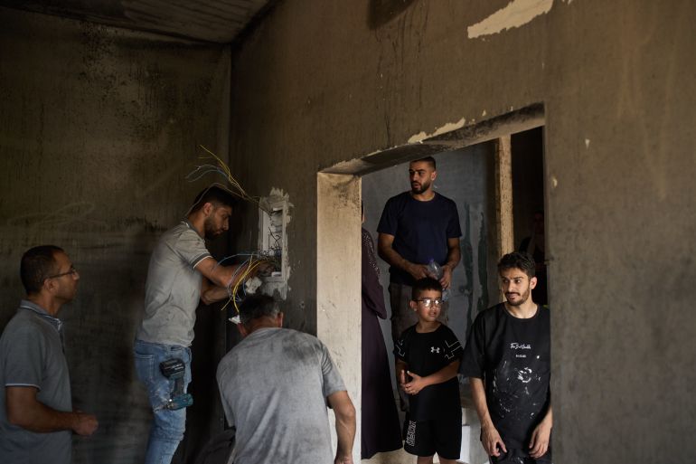 Palestinians repair a damaged house following an attack by Israeli settlers in the village of Sarra, near the West Bank city of Nablus, July 25, 2026