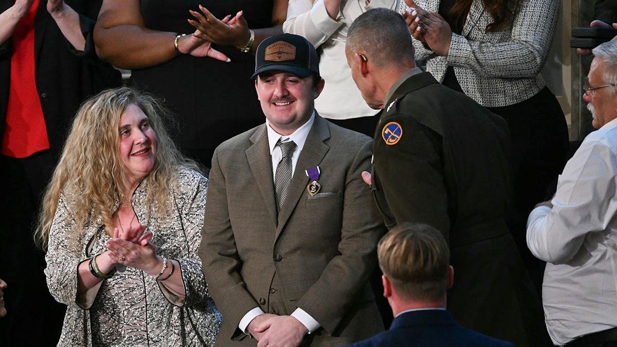 Andrew Wolfe receives a Purple Heart during a recognition in the House Chamber.