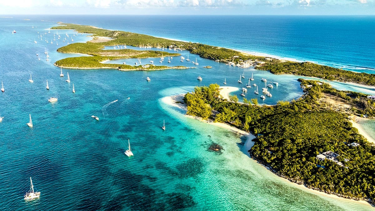 Beautiful Aerial View of Famous Chat'n'chill Conch bar in Stocking Island (Exuma - Bahamas) near George Town with many boats and Sailing Yachts Anchored