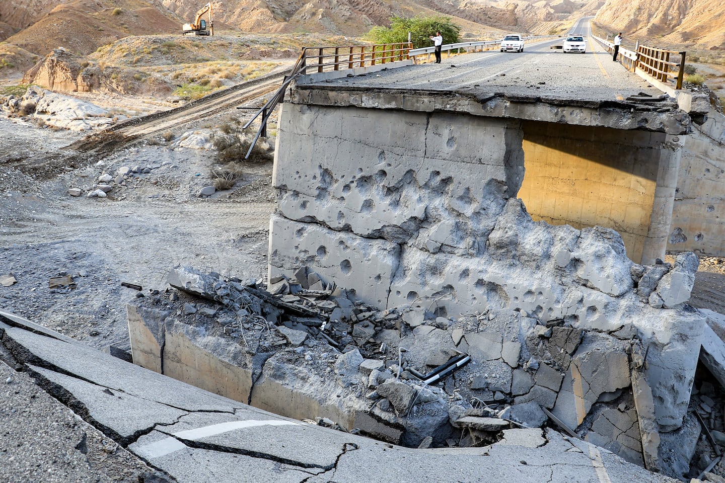 A heavily-damaged bridge which was hit by a US strike is pictured along the road connecting Roudan and Bandar Abbas in southern Iran on July 18, 2026. The United States hit Iran on July 17, with Tehran accusing US forces of striking civilians sites and drawing Iranian threats of reprisals on regional infrastructure. A battle over the strategic Strait of Hormuz has rekindled the war in the Middle East and the foes have traded fire for six days running.