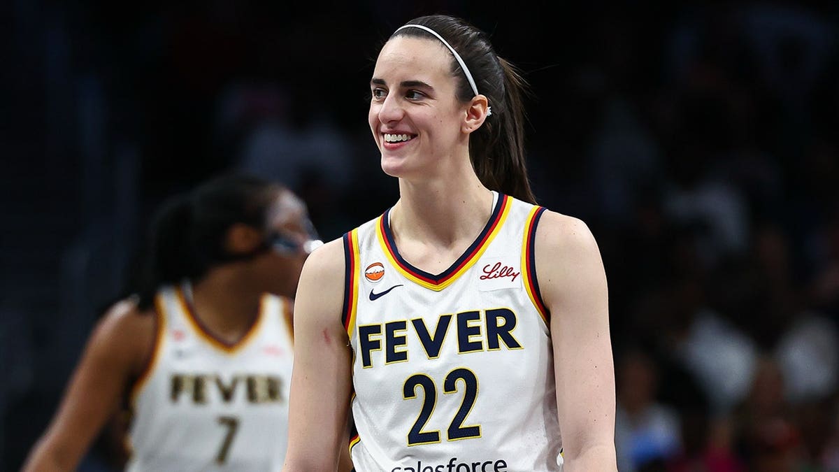 Caitlin Clark smiles on court