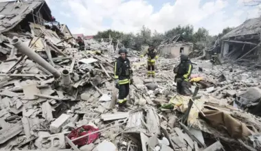 Firefighters stand in the rubble from a Russian attack in Zaporizhzhia on June 28.