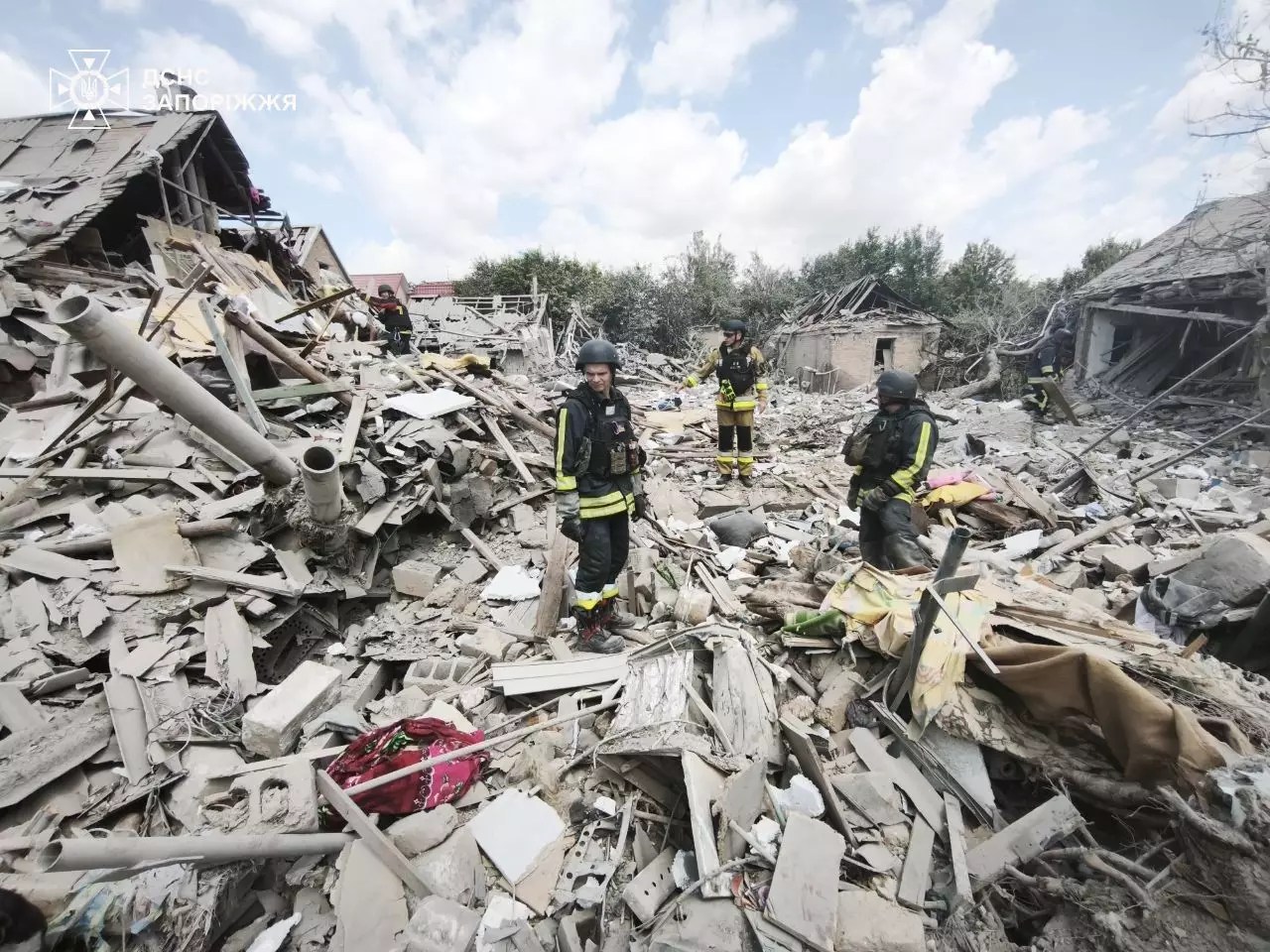Firefighters stand in the rubble from a Russian attack in Zaporizhzhia on June 28.