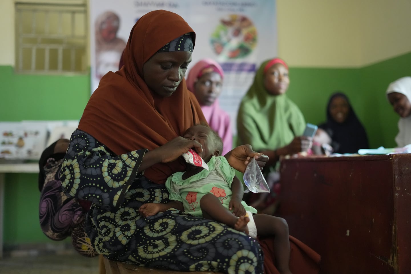 Larai Malami, a 35-year-old mother of 10, fed her child suffering from Malnutrition inside Rumbukawa Primary Health Centre in Sokoto, northwestern Nigeria, on Thursday.