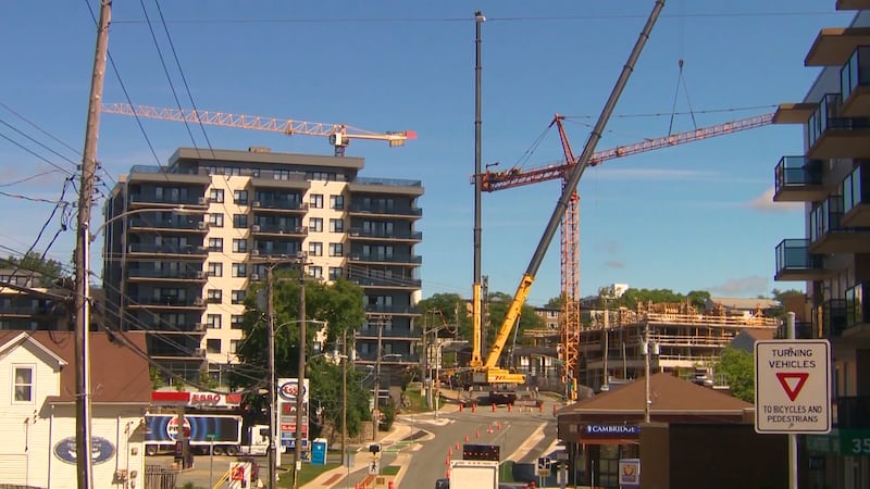 Construction crews work to dismantle a tower crane that was currently helping to build a mixed-use housing development on Dutch Village Road. (Jesse Thomas/CTV Atlantic)