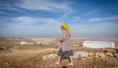 A woman walks near Tzur Misgavi, an illegal outpost in Gush Etzion, in the West Bank, November 17, 2025. (Chaim Goldberg/Flash90)