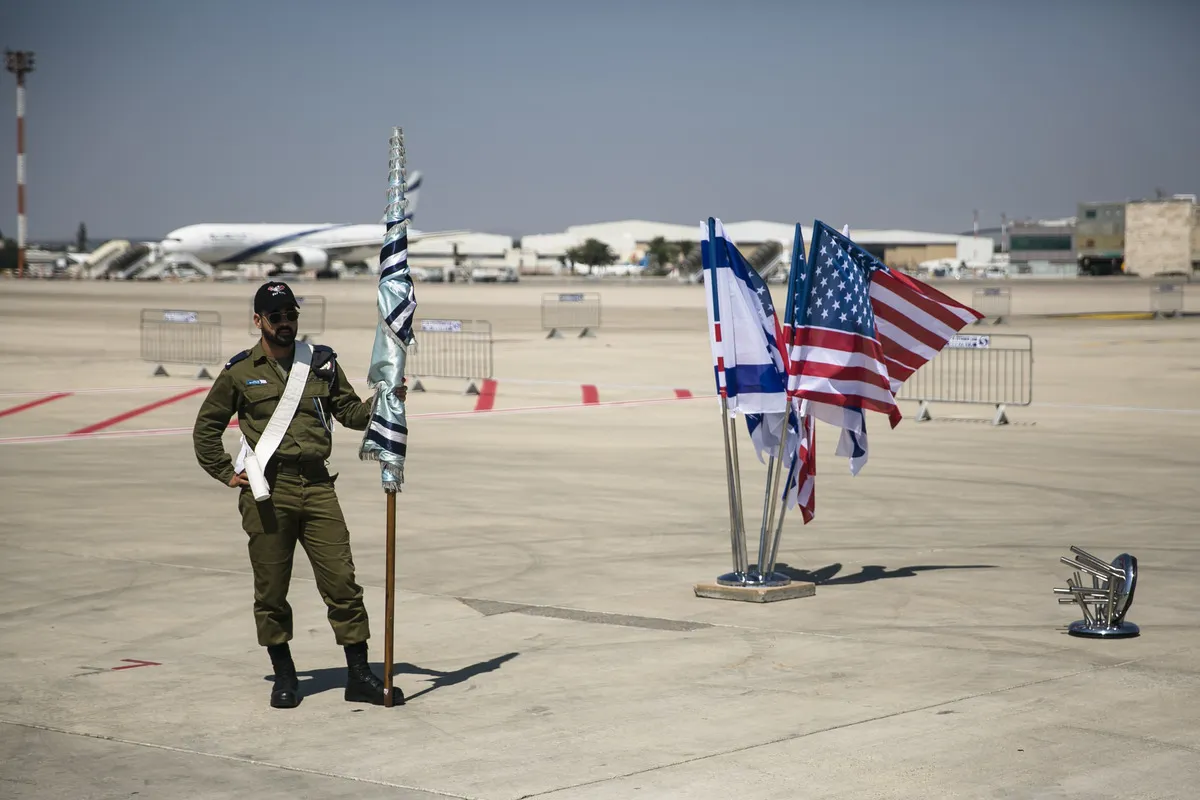 An Israeli soldier from the army orchestra rest during the final rehearsal for the ceremony to welcome then-U.S. President Joe Biden ahead of his visit to Israel on July 12, 2022 in Lod, Israel.