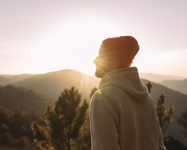 Young man practicing meditation in nature at sunrise - stock photo