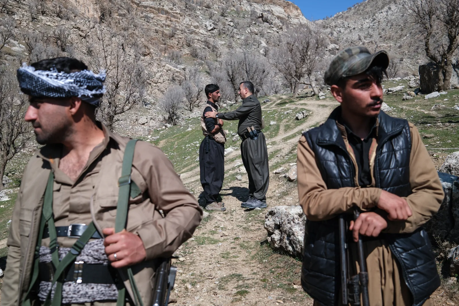 Members of the Komala of the Toilers of Kurdistan stand near their military bases hidden among the mountains on March 12, 2026, in Khalifa, Iraq.