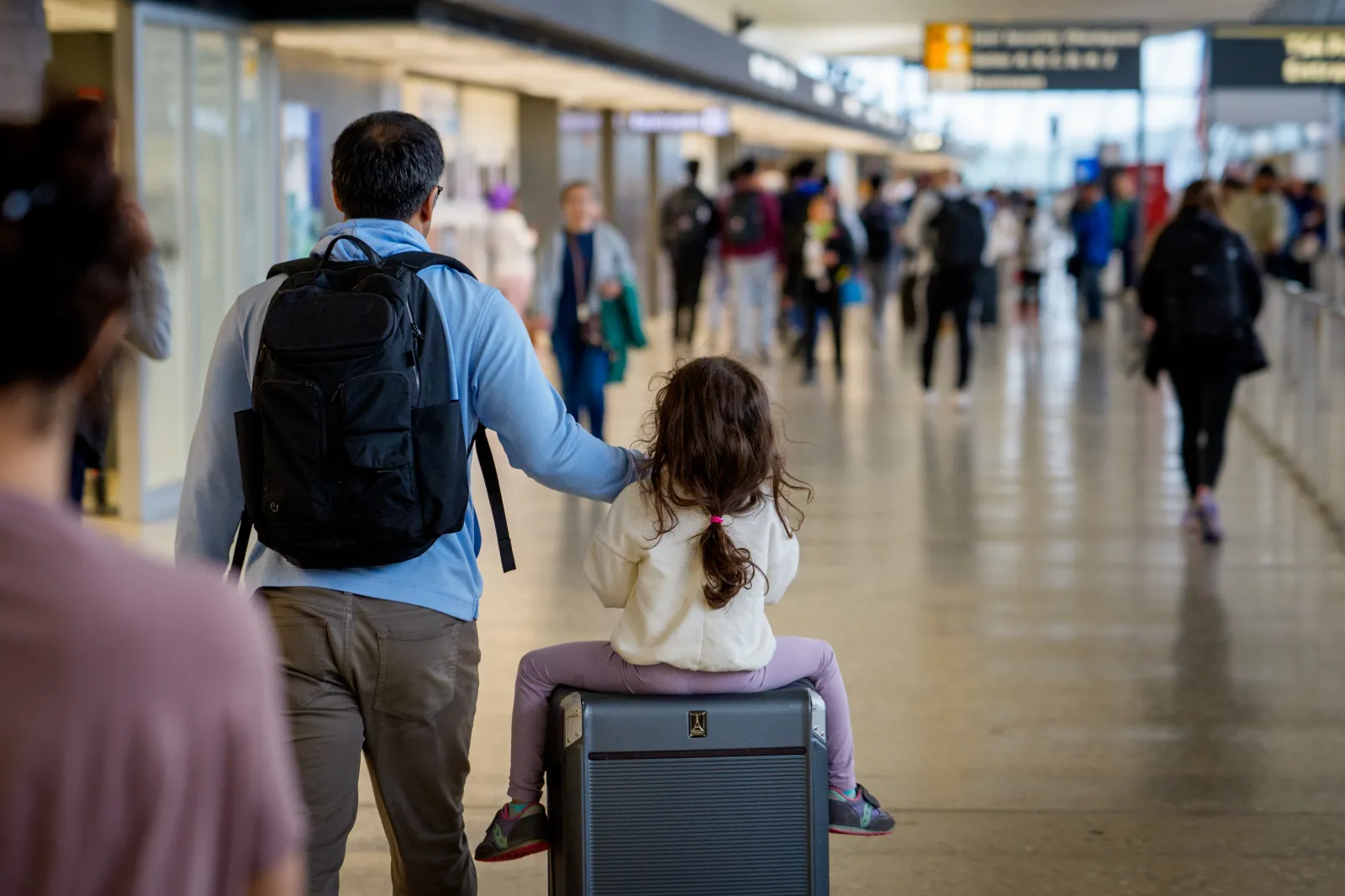Travelers move through Washington Dulles International Airport on May 22.