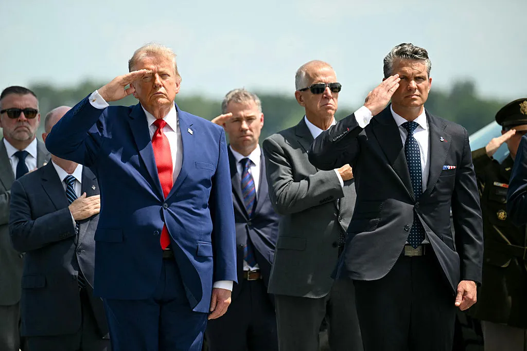 US President Donald Trump and US Secretary of Defense Pete Hegseth (R) salute during a dignified transfer solemn event for US service members killed during operations in the Middle East. (Photo by SAUL LOEB / AFP via Getty Images)