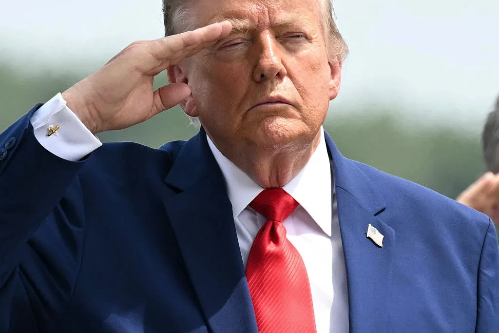 US President Donald Trump salutes as he attends a dignified transfer solemn event for US service members killed during operations in the Middle East, at Dover Air Force Base in Dover, Delaware, on July 22, 2026.  (Photo by SAUL LOEB / AFP via Getty Images)