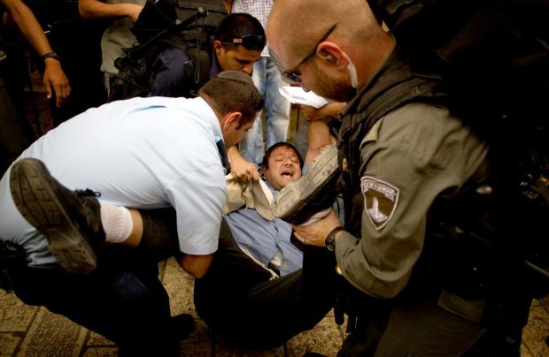 FILE - Israeli right wing activist Itamar Ben-Gvir is detained by police after shouting slogans at White House Chief of Staff Rahm Emanuel, during his visit to Jerusalem's old city Thursday, May 27, 2010. (AP Photo/Sebastian Scheiner, file)