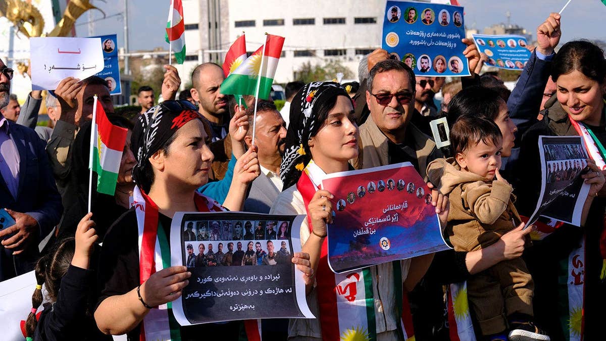 People take part in a march in Erbil, Iraq