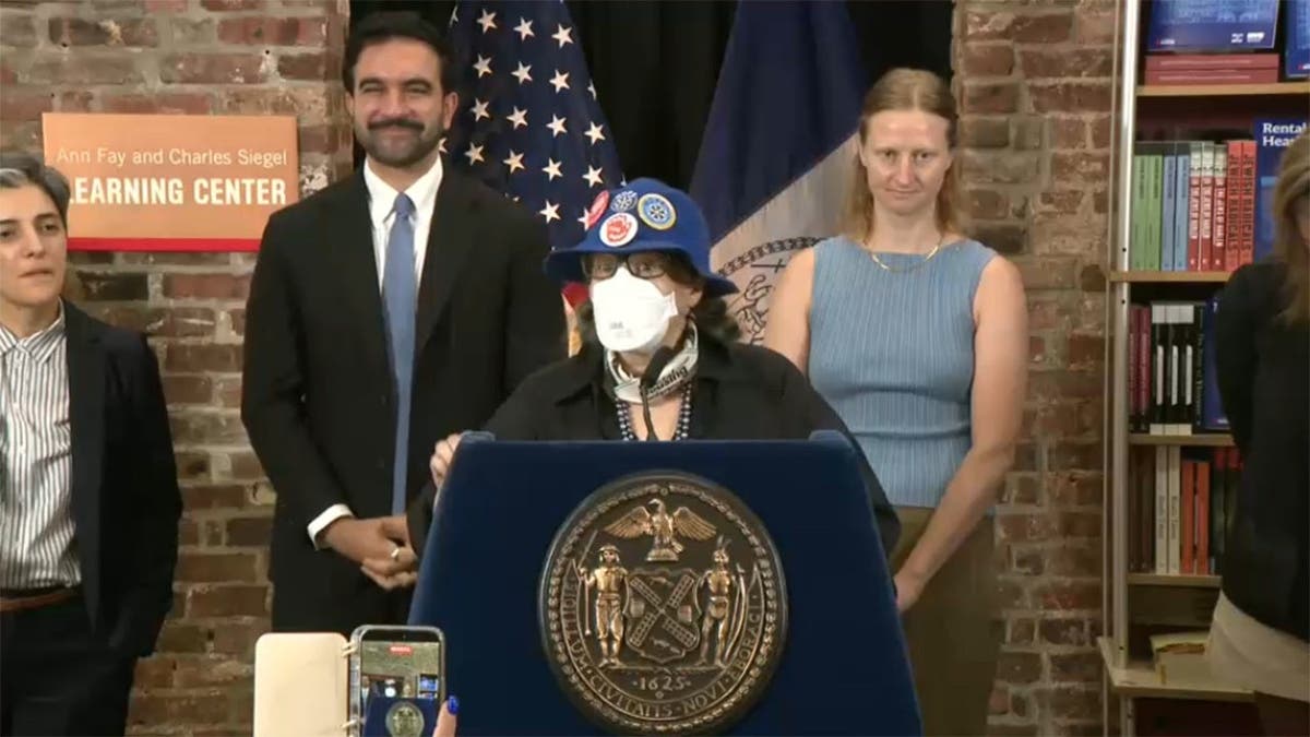 Mamdani stands behind woman at press conference