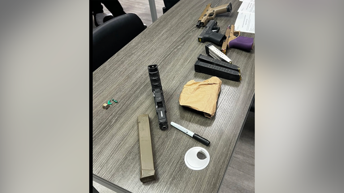 Firearms, magazines and other evidence recovered by North Charleston police after a July 4 block party where officers were assaulted and gunfire was reported
