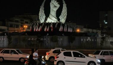 Vehicles drive past a monument depicting the clenched fist of the late Iranian Supreme Leader Ayatollah Ali Khamenei, who was killed in the US and Israel strike on Feb. 28, in Islamic Revolution Square in Tehran, on July 19.