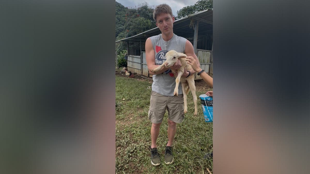 image shows victim holding a lamb.