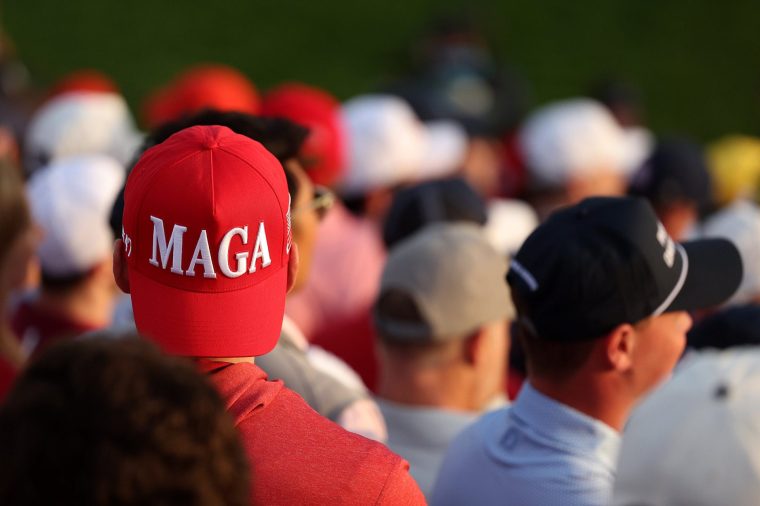 FARMINGDALE, NEW YORK - SEPTEMBER 27: A spectator in the first grandstand wears a 'MAGA' hat during the Saturday morning foursomes matches of the 2025 Ryder Cup at Black Course at Bethpage State Park Golf Course on September 27, 2025 in Farmingdale, New York. (Photo by Kate McShane/Getty Images)