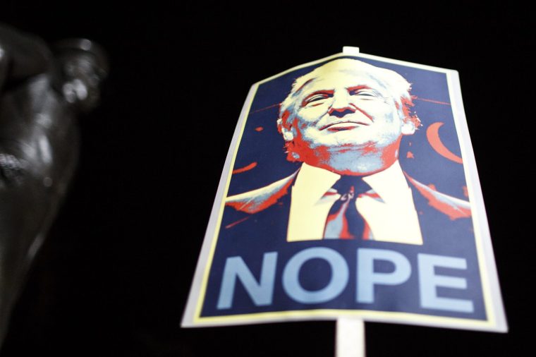 GROSVENOR SQUARE, LONDON, UNITED KINGDOM - 2017/01/20: An anti-Trump placard referencing artist Shepard Fairey's iconic "Hope" poster of Barack Obama is held up during a protest outside the US Embassy in Grosvenor Square, central London, on the day of Donald Trump's inauguration as US president. (Photo by David Cliff/SOPA Images/LightRocket via Getty Images)