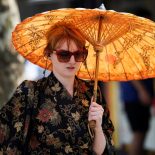 A woman shelters herself beneath an umbrella amid a heatwave, as Britain experiences record temperatures that disrupts schools and transport networks, in Manchester, Britain June 26, 2026. REUTERS/Temilade Adelaja