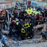 Members of the French Civil Security Training and Intervention Regiment (UIISC 7), US rescuers and other emergency personnel work at collapsed buildings in Caraballeda, La Guaira state, Venezuela, on June 28, 2026, following earthquakes. Thousands of rescuers, relatives and volunteers dig day and night through mounds of concrete to find survivors of the earthquakes that struck Venezuela more than three days ago, leaving nearly 1,500 dead and tens of thousands missing. (Photo by Miguel MEDINA / POOL / AFP via Getty Images)
