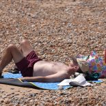 People enjoy the hot weather on Hastings beach. Temperatures are set to continue to rise across the UK throughout the week, and more regions are likely to reach their local heatwave thresholds. Picture date: Thursday July 9, 2026. PA Photo. Photo credit should read: Gareth Fuller/PA Wire