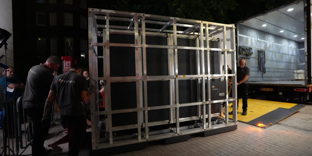 Workers unload a box that contains the Bayeux Tapestry out of a truck at the British Museum in London, Friday, July 10, 2026. (AP Photo/Kwiyeon Ha)