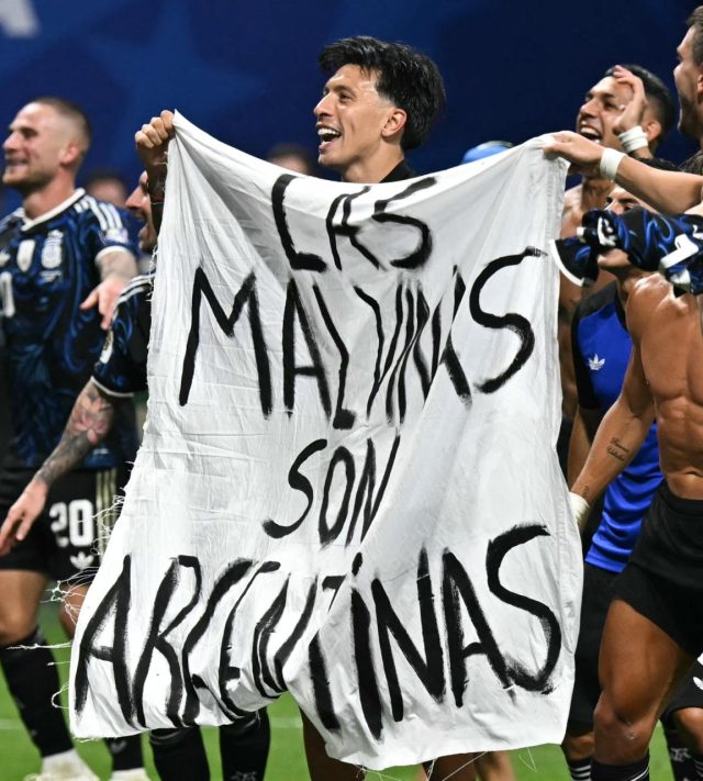 Argentina's players hold a banner reading "The Malvinas (Falkland Islands) belong to Argentina," after winning the 2026 World Cup football tournament semi-final match between England and Argentina at the Atlanta Stadium in Atlanta on July 15, 2026. (Photo by Paul ELLIS / AFP via Getty Images)