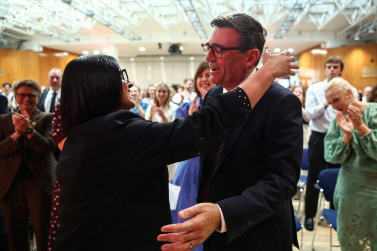 Andy Burnham (R) hugs Britain's current Home Secretary Shabana Mahmood (L) after he is confirmed as the Labour Party's new leader and the country's next prime minister, during 'Labour's Special Conference' in central London on July 17, 2026. (Photo by Henry NICHOLLS / POOL / AFP via Getty Images)