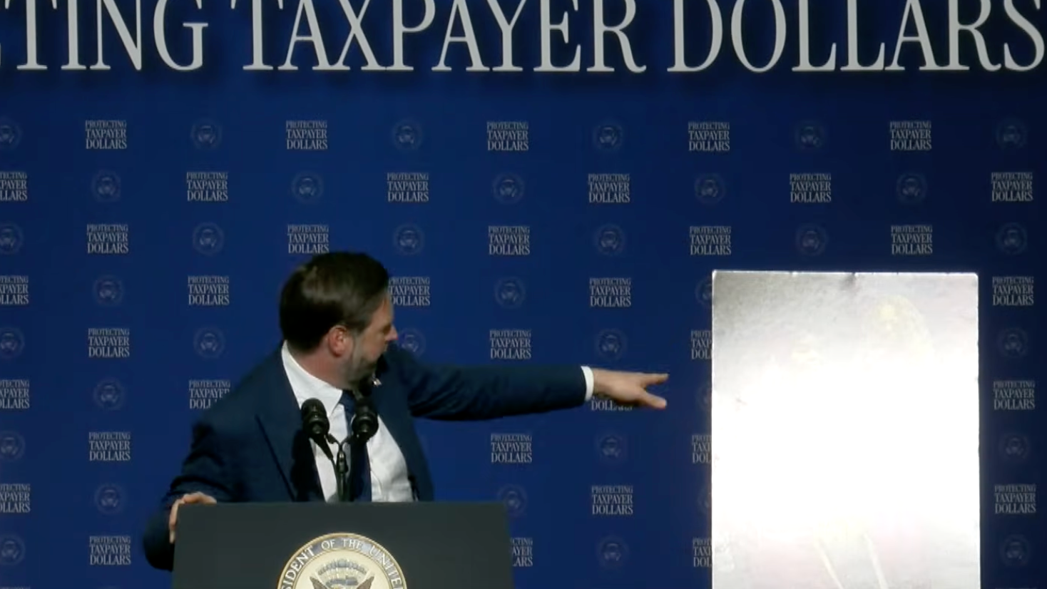 Vice President JD Vance points to a photo of a convicted fraudster on stage in Milwaukee, Wisconsin – though the photo was blown-out by stage lighting